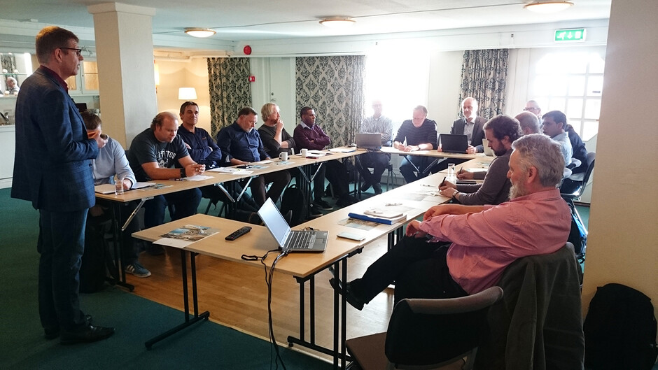 All the participants around the table, listening to Rein Terje Thorstensen.